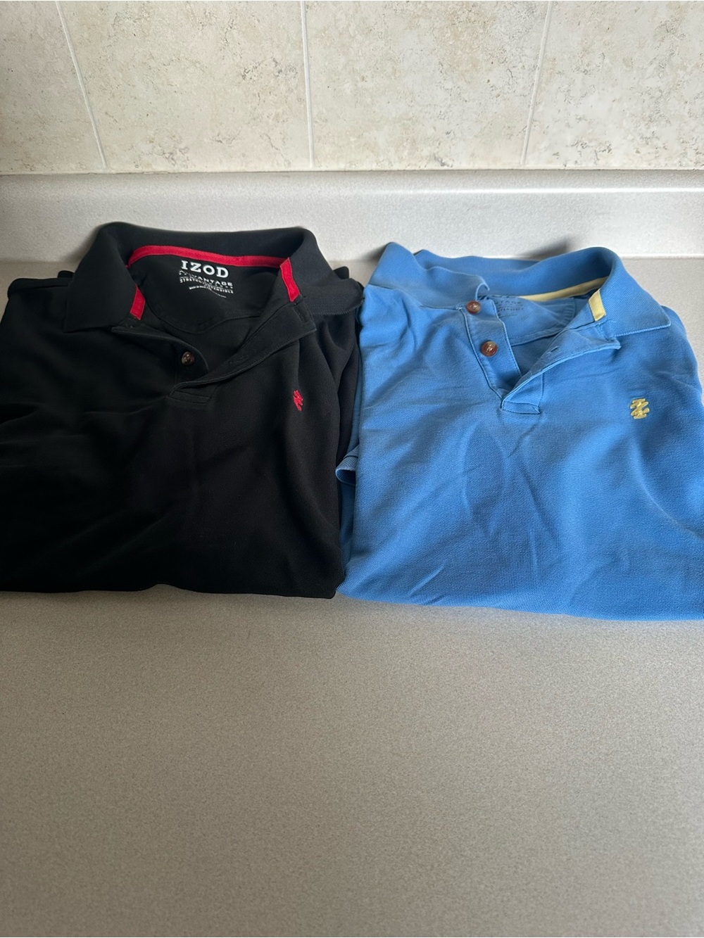Izod Men’s Black and Light Blue Polo Shirts - Pack of 2